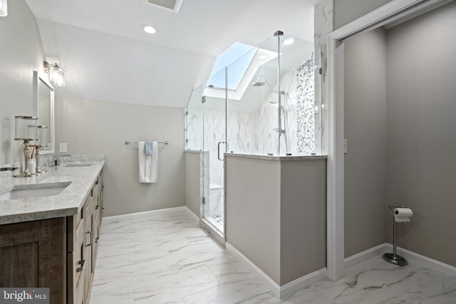 bathroom featuring marble finish floor, a sink, lofted ceiling, double vanity, and baseboards