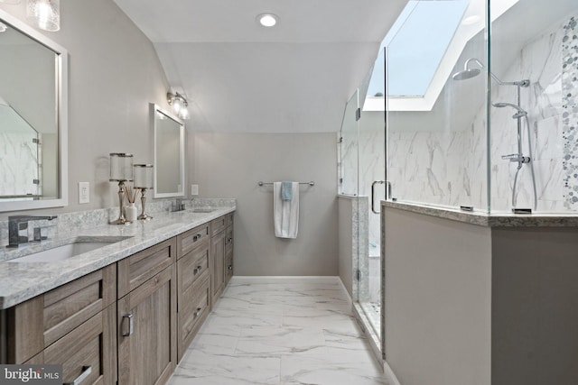 bathroom with double vanity, marble finish floor, a sink, and a marble finish shower