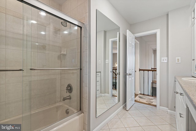 full bath featuring shower / bath combination with glass door, vanity, baseboards, and tile patterned flooring