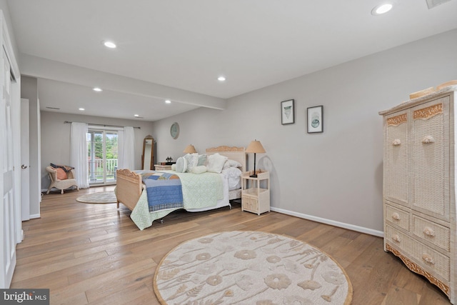 bedroom with hardwood / wood-style floors, access to exterior, baseboards, and recessed lighting