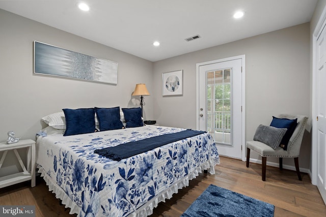 bedroom featuring recessed lighting, visible vents, access to outside, and wood finished floors