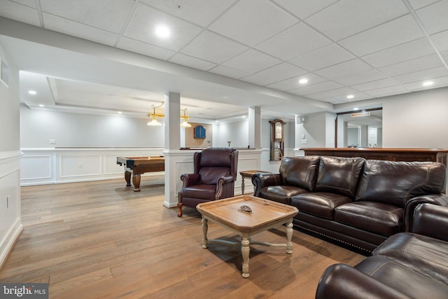 living area with light wood-style floors, recessed lighting, a wainscoted wall, billiards, and indoor bar
