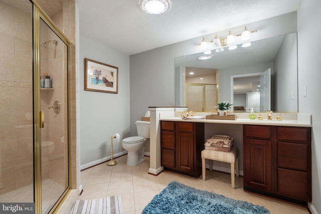 full bath with tile patterned floors, a stall shower, a sink, and toilet