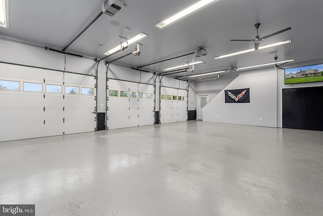 garage with a ceiling fan and a garage door opener