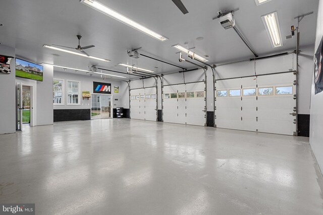 garage with a garage door opener and ceiling fan