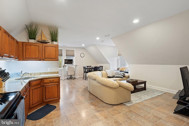 interior space with plenty of natural light, baseboards, and vaulted ceiling