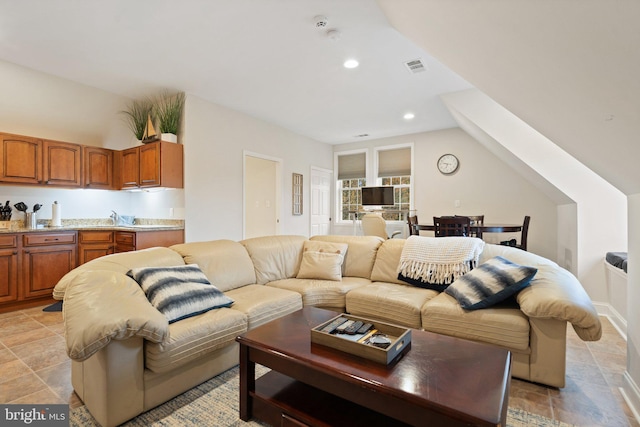 living area featuring vaulted ceiling, visible vents, and recessed lighting