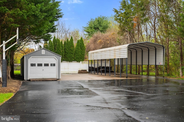 detached garage with driveway and fence