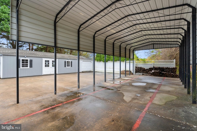 view of parking featuring a detached carport and fence