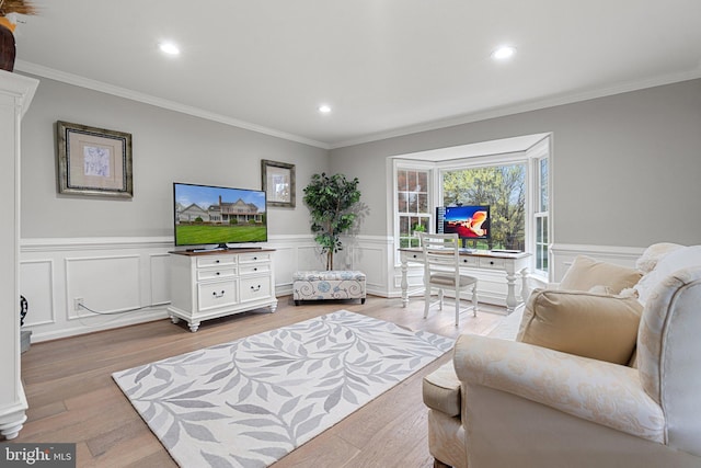 living area with crown molding, recessed lighting, and light wood-style floors
