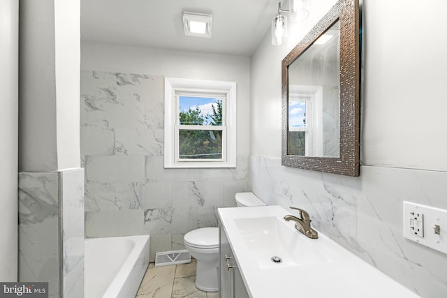 bathroom featuring visible vents, a bath, toilet, vanity, and marble finish floor