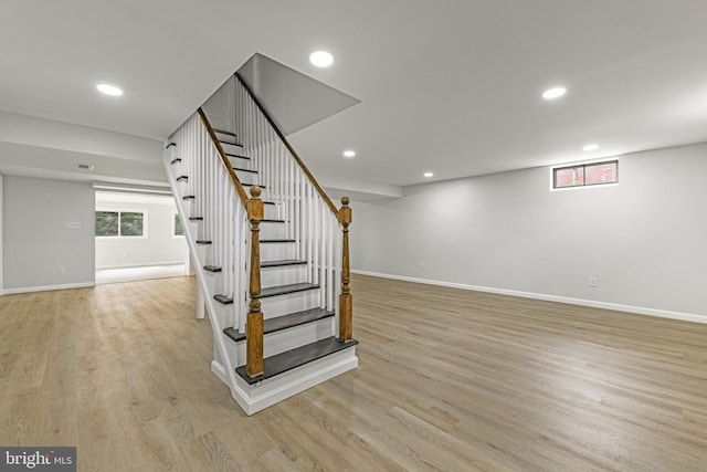 interior space featuring recessed lighting, baseboards, and wood finished floors
