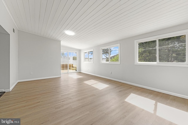 empty room featuring visible vents, baseboards, wooden ceiling, and wood finished floors