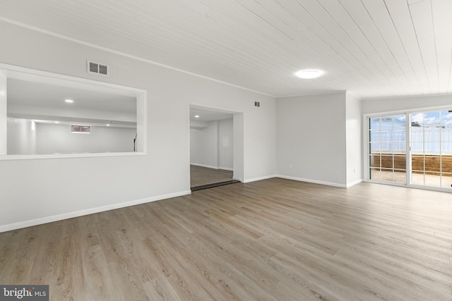unfurnished living room featuring visible vents, baseboards, wooden ceiling, and wood finished floors