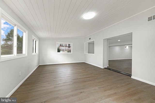 interior space featuring visible vents, baseboards, wooden ceiling, and wood finished floors