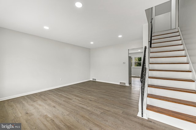 stairway featuring visible vents, recessed lighting, and wood finished floors
