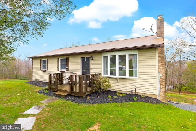 11 Solar Dr, New Providence, PA 17560 - rear view of property with a wooden deck, a lawn, and a chimney
