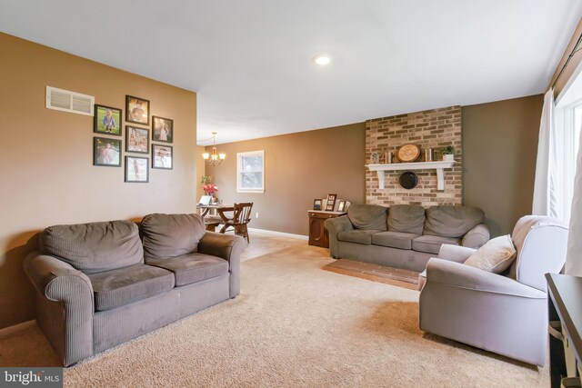11 Solar Dr, New Providence, PA 17560 - living room with visible vents, baseboards, a notable chandelier, and light carpet