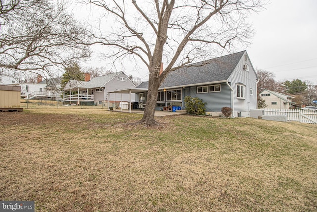827 Crothers Ln, Rockville, MD 20852 - back of property with a yard, fence, and a shingled roof