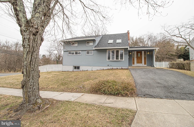 827 Crothers Ln, Rockville, MD 20852 - view of front of property featuring aphalt driveway, fence, a chimney, and a front yard