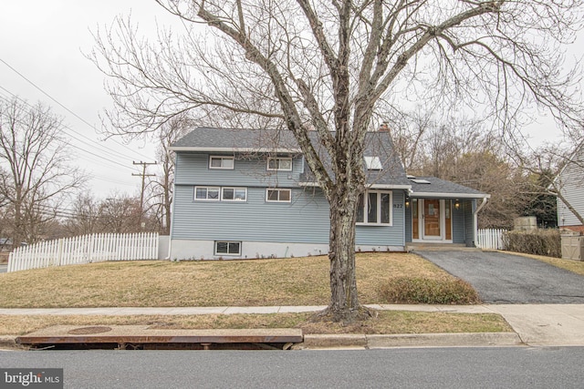 827 Crothers Ln, Rockville, MD 20852 - view of front of home featuring fence, a front lawn, a chimney, a shingled roof, and driveway