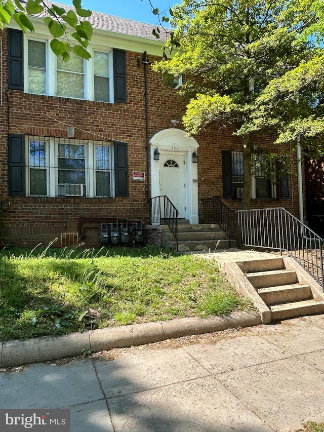 townhome / multi-family property with brick siding