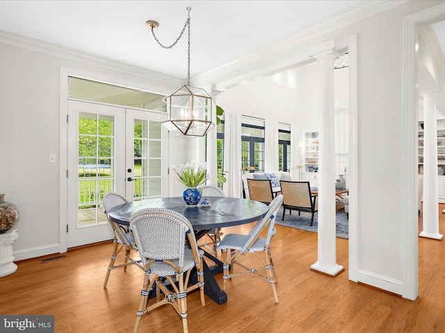 dining space featuring french doors, light wood-style floors, visible vents, and baseboards