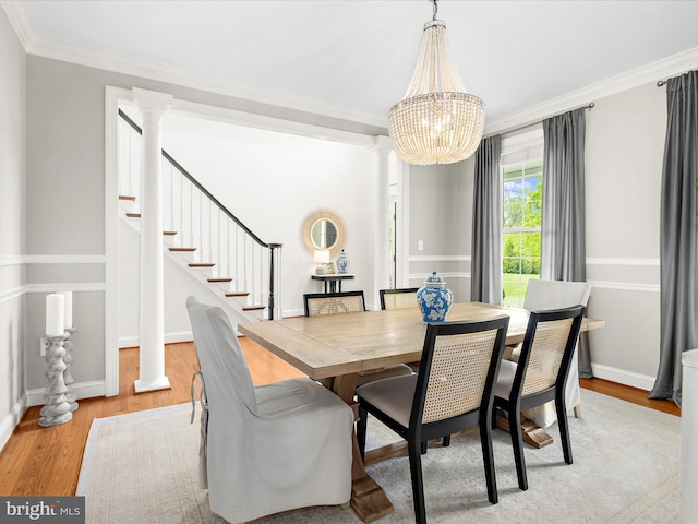 dining area featuring ornamental molding, wood finished floors, and a chandelier
