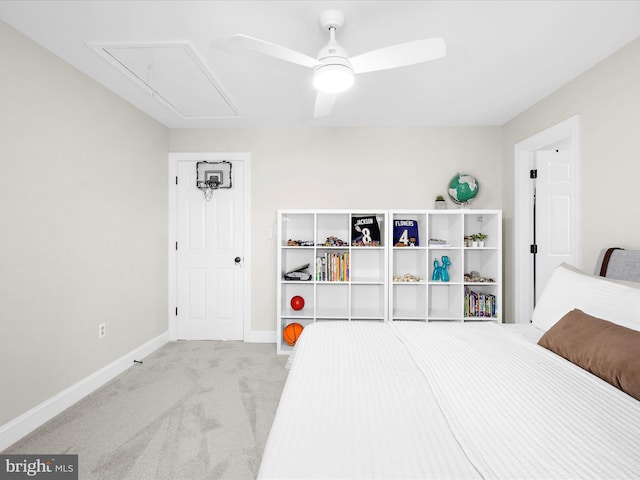 carpeted bedroom with attic access, a ceiling fan, and baseboards