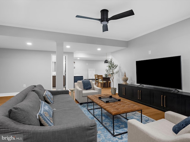 living area with recessed lighting, a ceiling fan, wood finished floors, and baseboards
