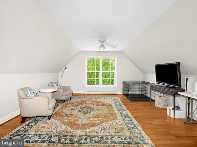 sitting room featuring wood finished floors, a baseboard radiator, baseboards, a ceiling fan, and lofted ceiling