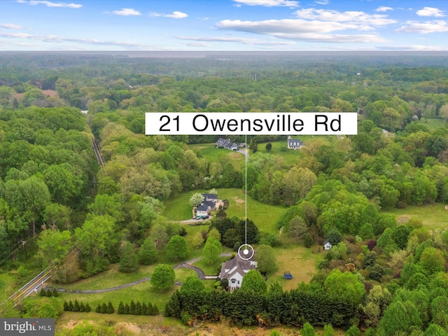 birds eye view of property with a wooded view