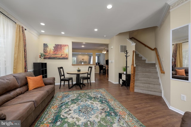 living area featuring recessed lighting, wood finished floors, visible vents, and stairs