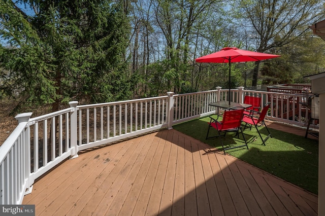deck with outdoor dining area