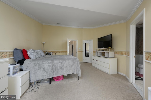 bedroom with visible vents, light carpet, ornamental molding, connected bathroom, and wainscoting