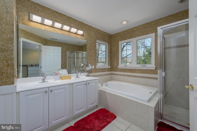 full bath with a garden tub, tile patterned flooring, a stall shower, and a sink