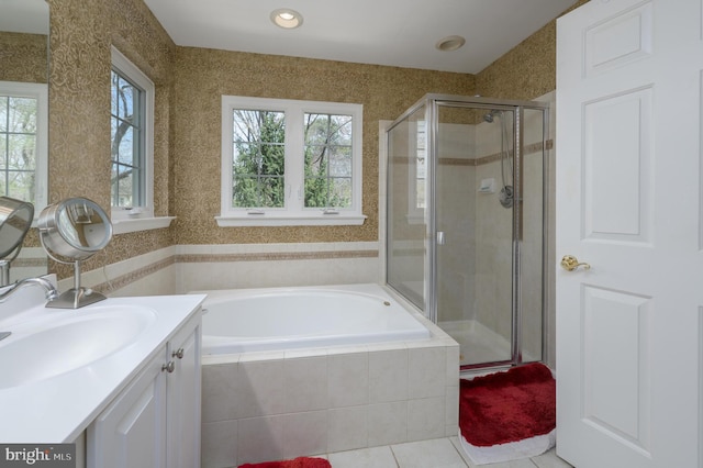 bathroom with a garden tub, vanity, tile patterned floors, and a stall shower