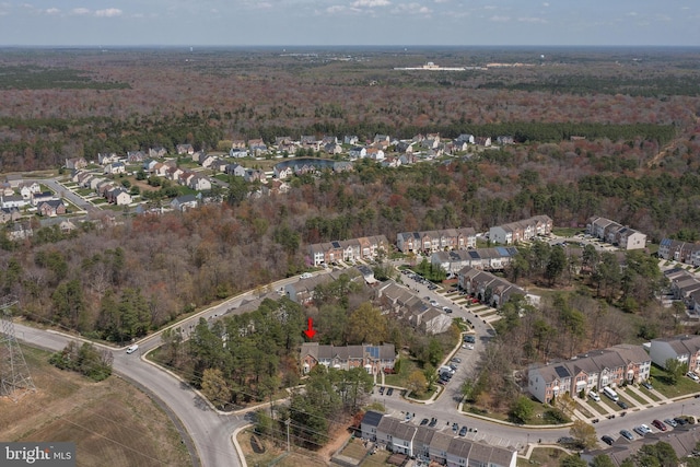 drone / aerial view featuring a wooded view