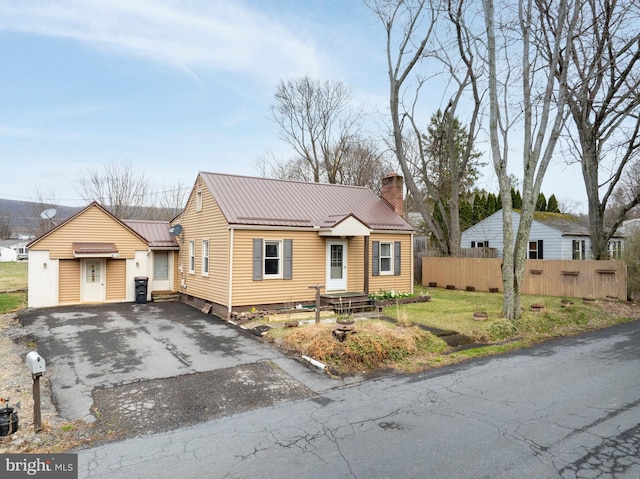 139 Kimport Ave, Boalsburg, PA 16827 - view of front facade with a chimney, fence, metal roof, and asphalt driveway