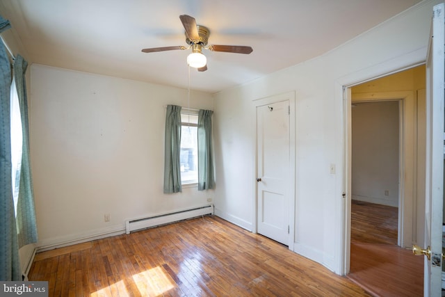 139 Kimport Ave, Boalsburg, PA 16827 - unfurnished bedroom featuring a baseboard heating unit, hardwood / wood-style flooring, a ceiling fan, and baseboards