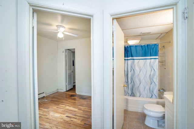 139 Kimport Ave, Boalsburg, PA 16827 - full bath with toilet, a ceiling fan, a baseboard heating unit, shower / bathtub combination with curtain, and wood finished floors
