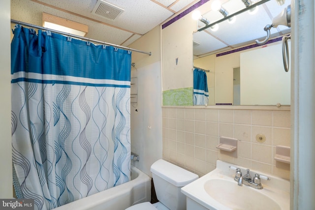 139 Kimport Ave, Boalsburg, PA 16827 - bathroom featuring tile walls, shower / bath combination with curtain, decorative backsplash, toilet, and vanity