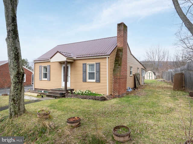 139 Kimport Ave, Boalsburg, PA 16827 - view of front facade featuring a shed, a chimney, a fire pit, metal roof, and an outdoor structure