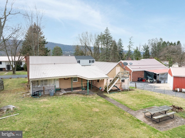 139 Kimport Ave, Boalsburg, PA 16827 - rear view of property featuring a lawn, metal roof, and a chimney