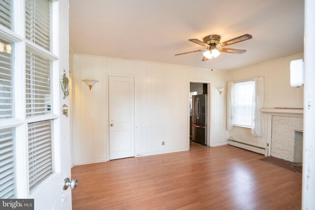 139 Kimport Ave, Boalsburg, PA 16827 - unfurnished bedroom with a baseboard radiator, freestanding refrigerator, wood finished floors, crown molding, and a ceiling fan