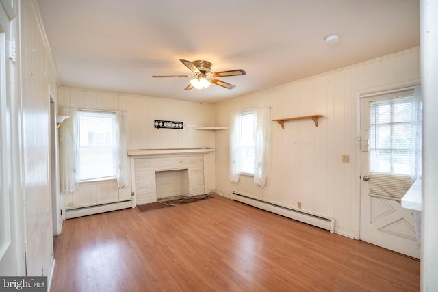 139 Kimport Ave, Boalsburg, PA 16827 - unfurnished living room featuring baseboard heating, ceiling fan, wood finished floors, and healthy amount of natural light