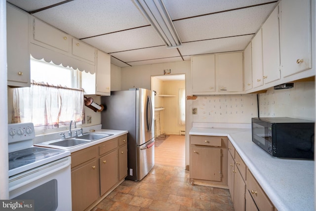 139 Kimport Ave, Boalsburg, PA 16827 - kitchen with white electric range oven, black microwave, a sink, light countertops, and a baseboard radiator