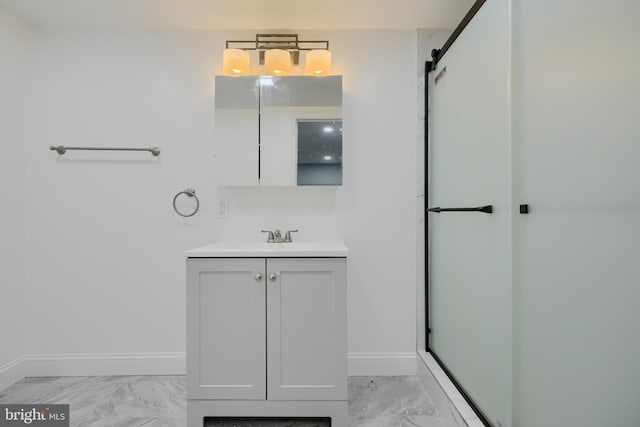 bathroom with baseboards, a shower with shower door, vanity, and marble finish floor