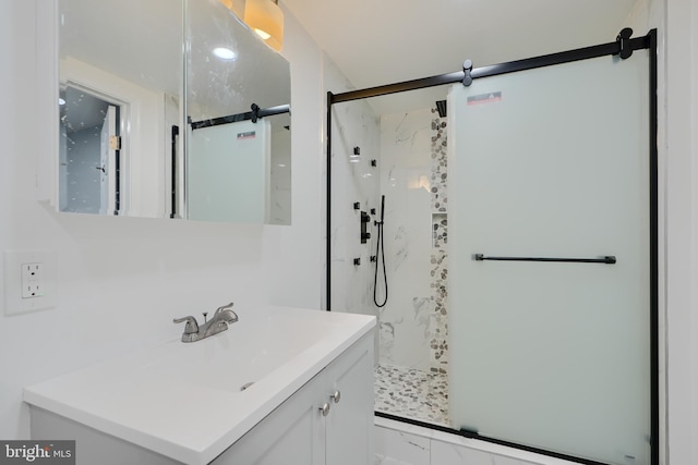 full bath with a stall shower and vanity