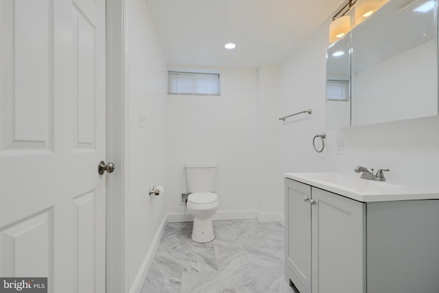 bathroom featuring recessed lighting, marble finish floor, toilet, vanity, and baseboards